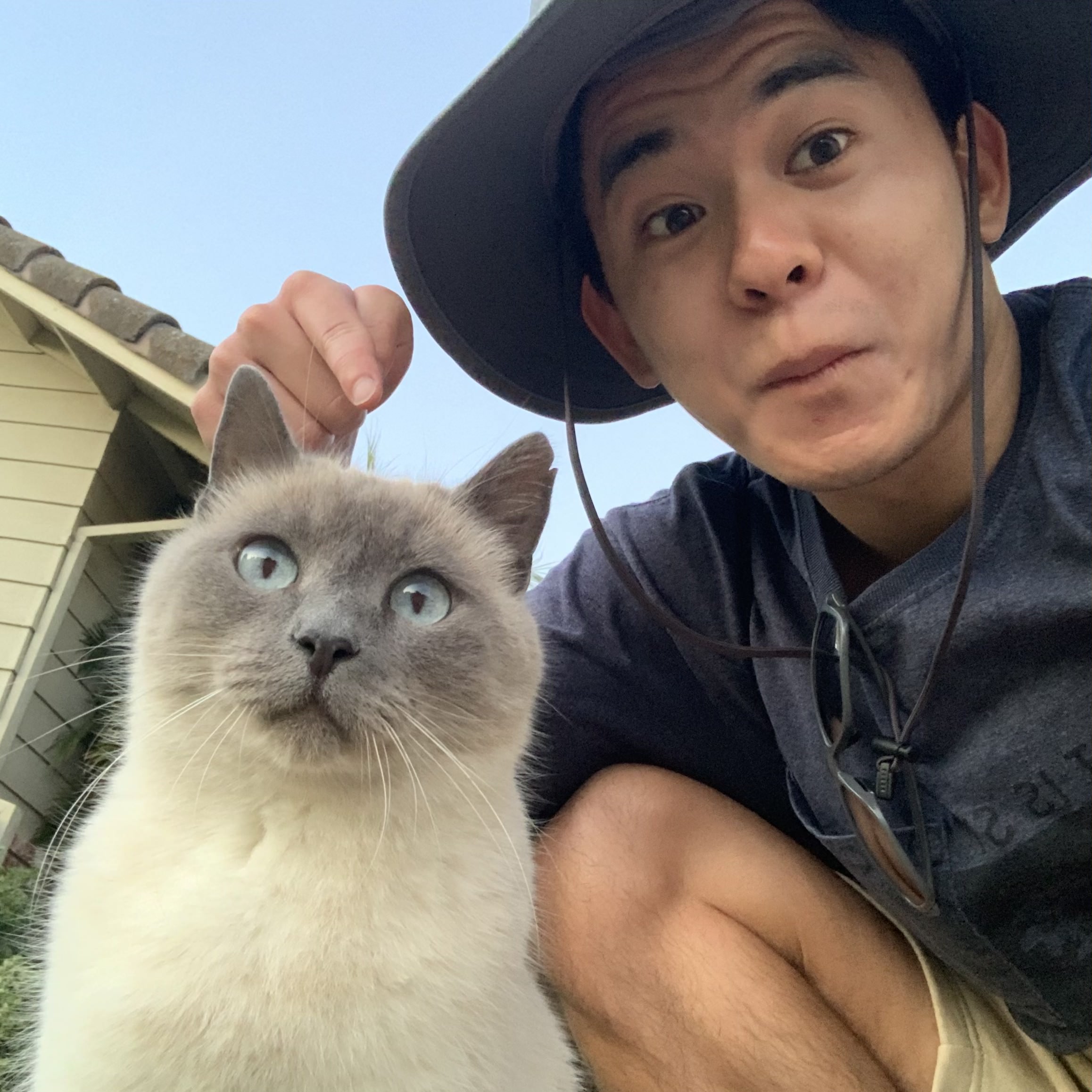 A silly profile picture. Me posing with a random cat